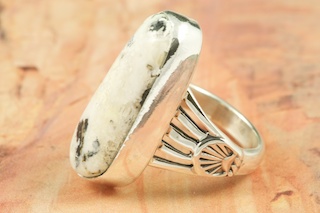 White Buffalo Turquoise set in Sterling Silver Ring. This Beautiful Stone is formed from the minerals Calcite and Iron. It is mined near Tonopah Nevada. Created by Navajo Artist Jake Sampson. Signed. 
